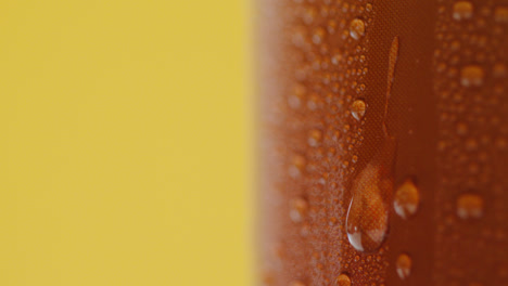 Close-Up-Of-Condensation-Droplets-Running-Down-Takeaway-Can-Of-Cold-Beer-Or-Soft-Drink-Against-Yellow-Background-1